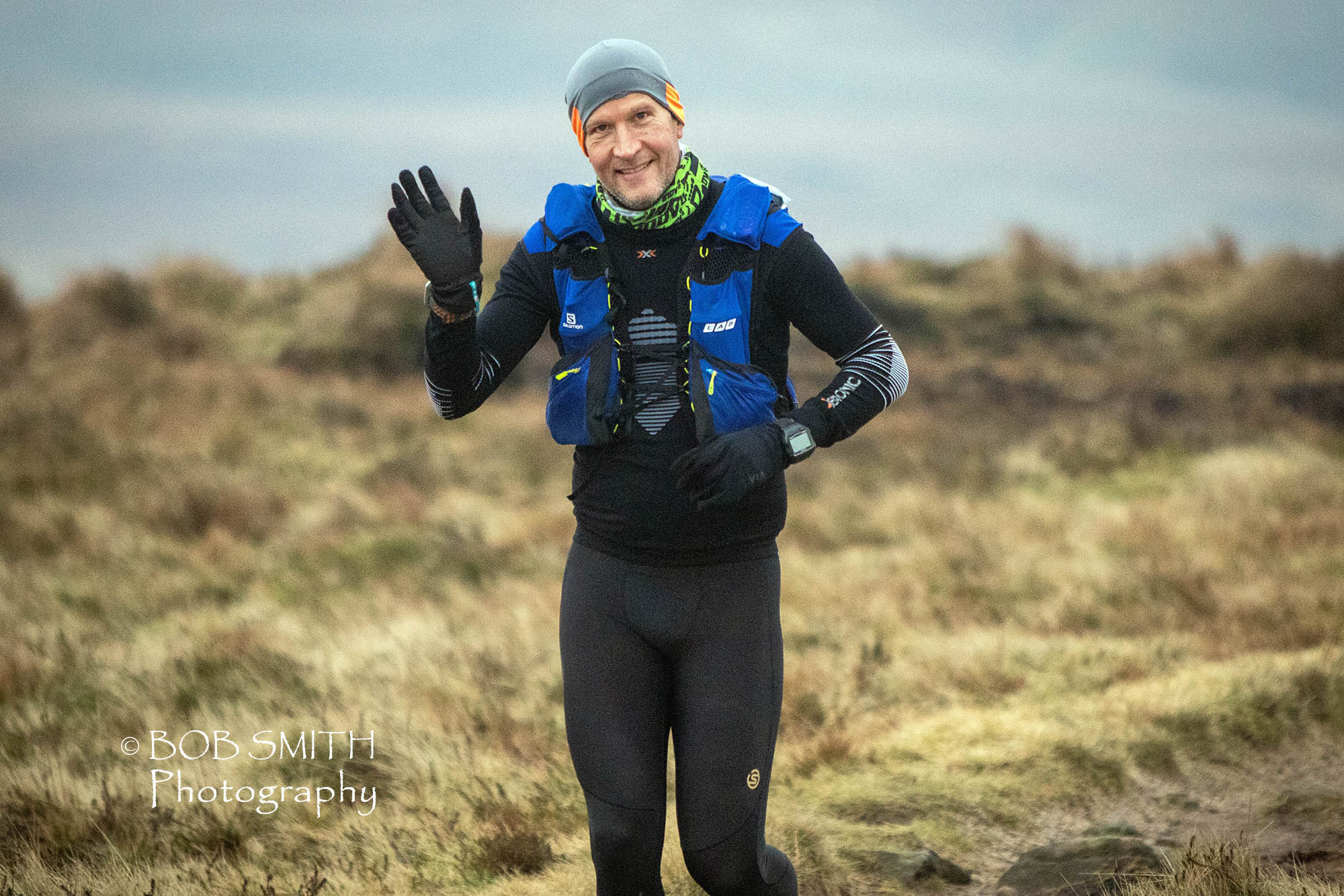 Tom Hollins gives a cheery wave as he tackles The Spine Race