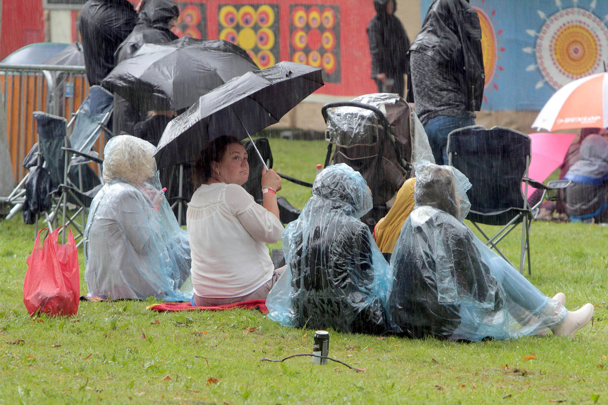 Festival-goers at the Aired brave a typical British summer downpour