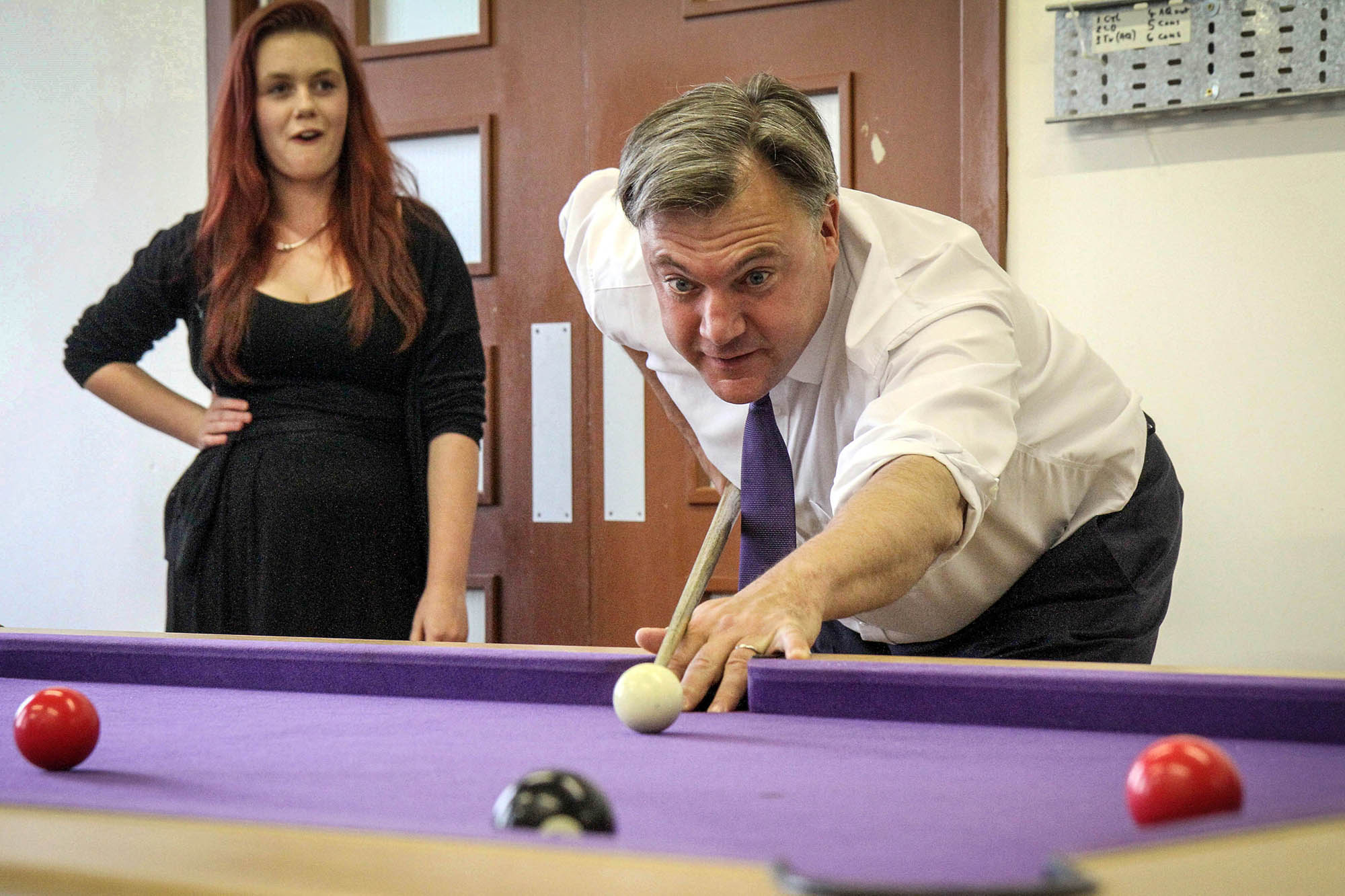 Ed Balls prepares to pot a pool ball on a visit to Keighley