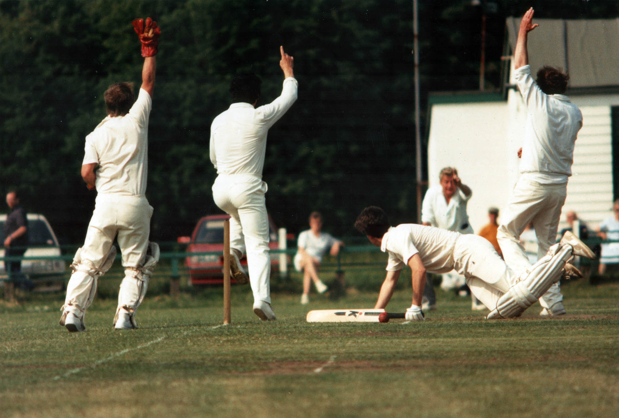 The umpire raises his finger to confirm the batter has been run out