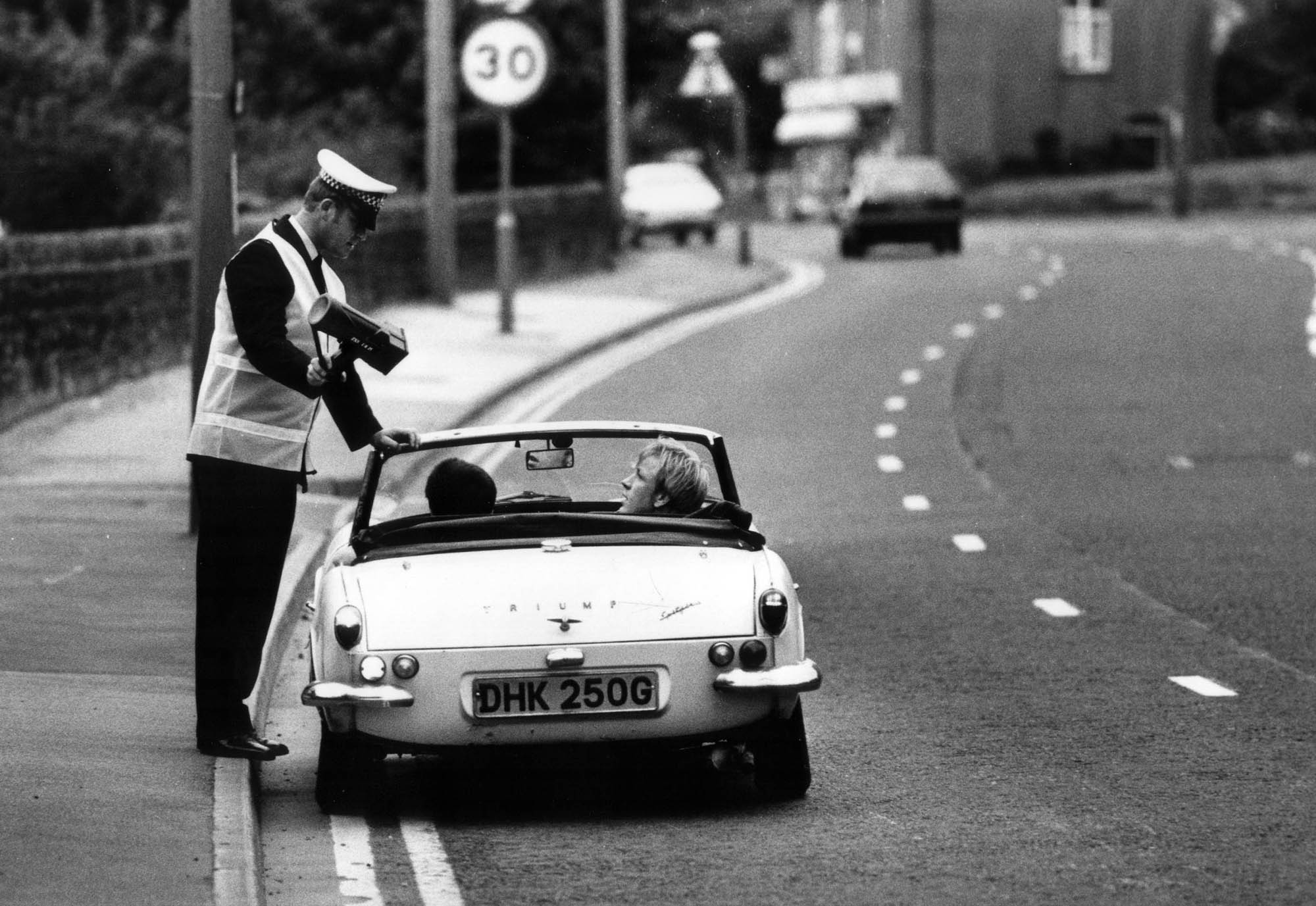 A police officer shows a driver his speed on the radar gun