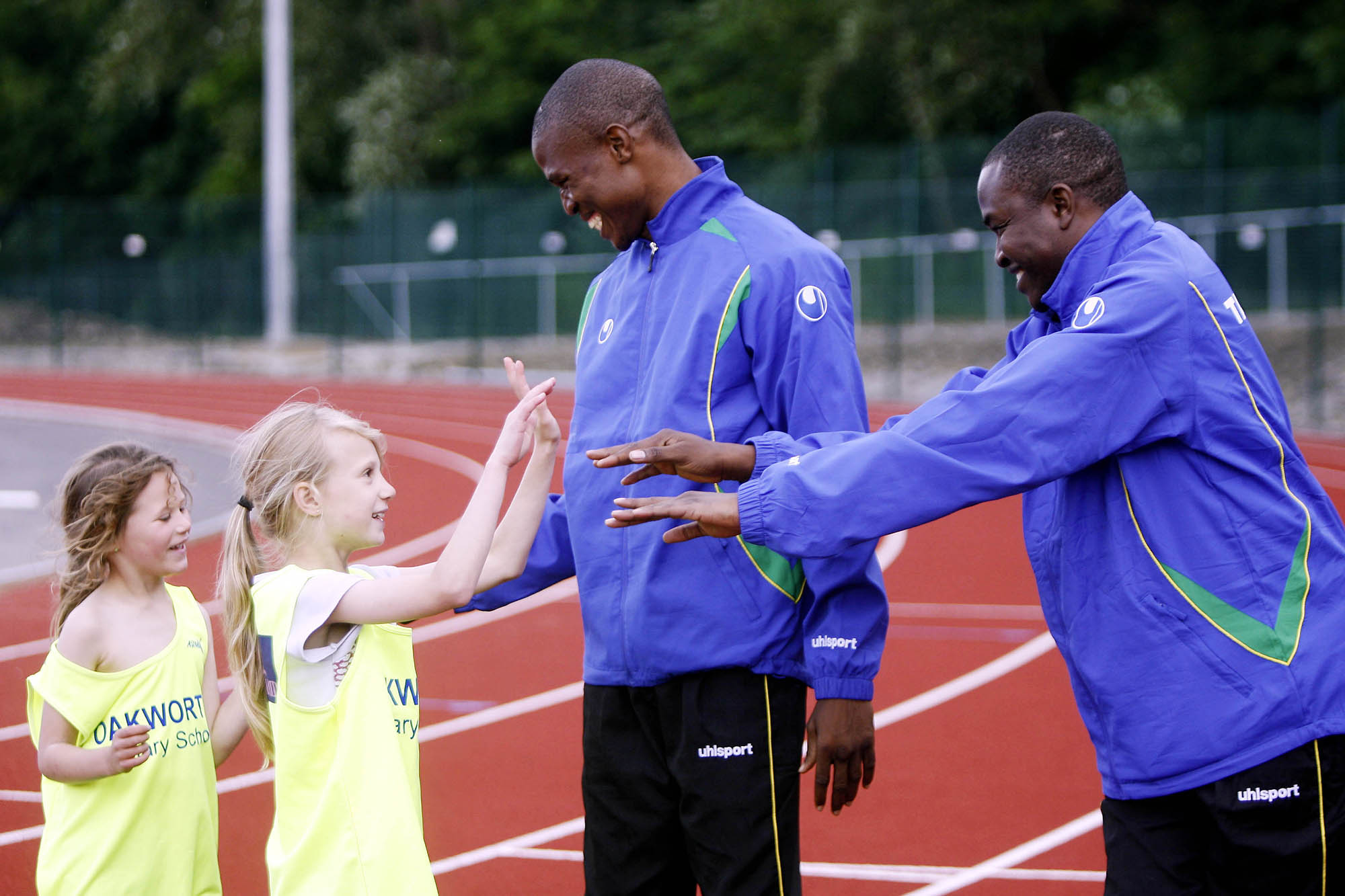 Tanzanian Olympic athletes congratulate Oakworth Primary School pupils during the training session at University Academy, Keighley