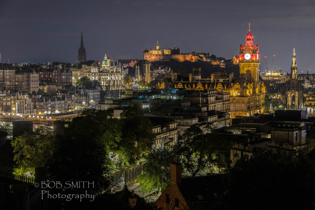 Edinburgh by night, with the castle centre, the Balmoral Hotel and Scott Monument on the right.