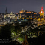 Edinburgh by night, with the castle centre, the Balmoral Hotel and Scott Monument on the right.