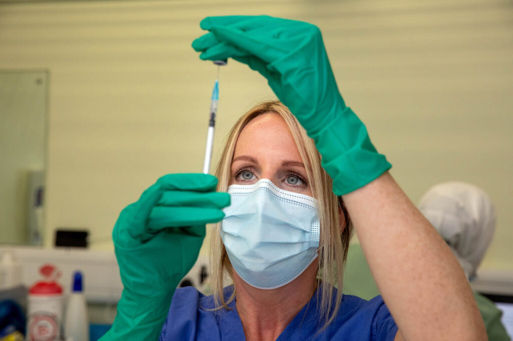 A nurse prepares to administer Covid vaccine