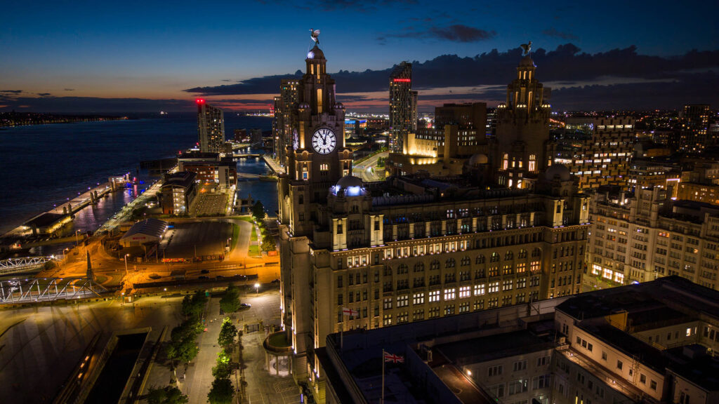 A drone shot of Liverpool Waterfront by night
